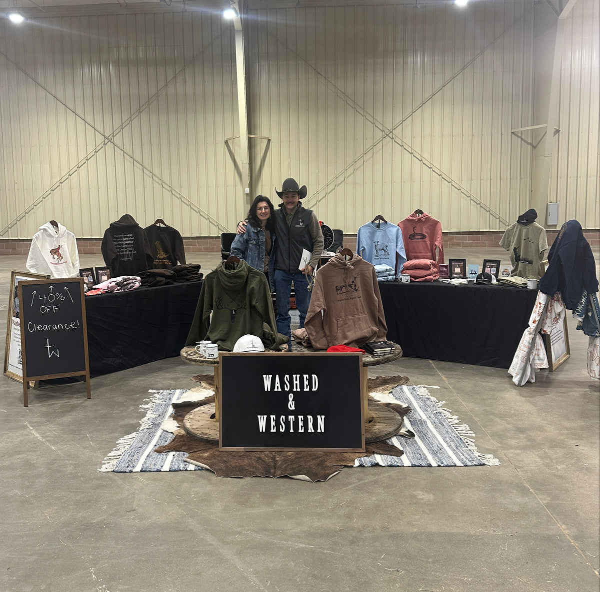 People standing in a room with a 'Washed & Western' sign on a table.